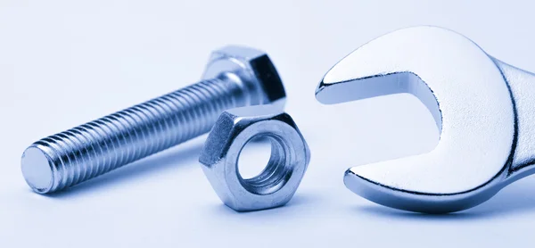 Screw bolt, nut and metallic wrench — Stock Photo, Image