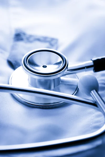 Stethoscope on white medical coat — Stock Photo, Image