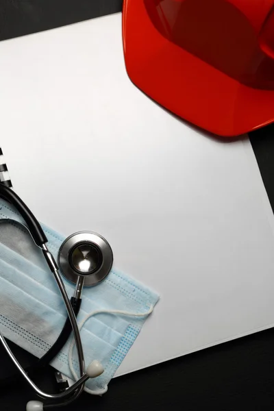 Manual with red helmet and stethoscope — Stock Photo, Image