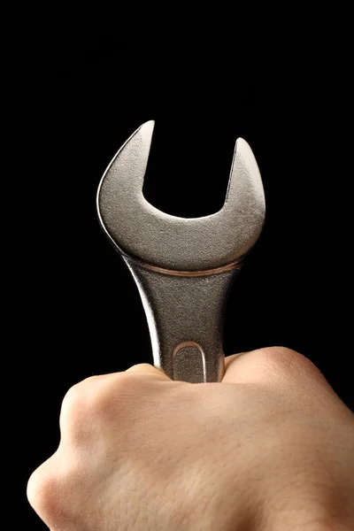 Metallic wrench in male hand — Stock Photo, Image