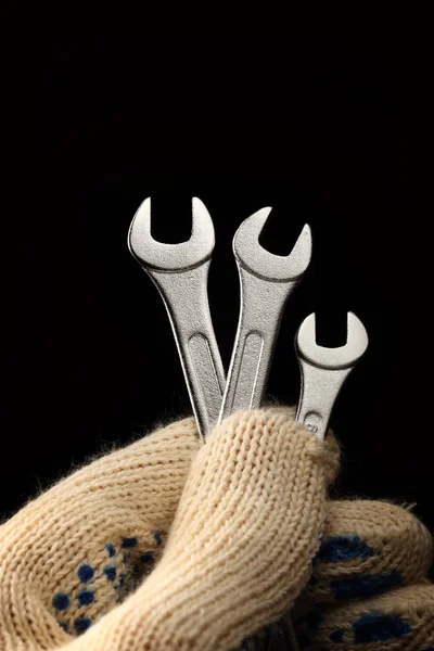 Metallic wrenches in male hand — Stock Photo, Image