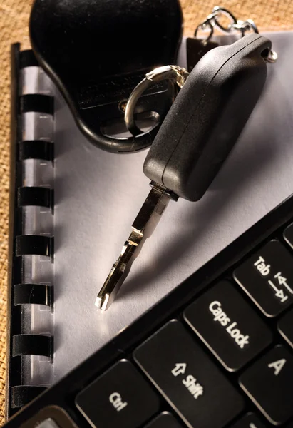 Cahier, clé de voiture et clavier d'ordinateur — Photo