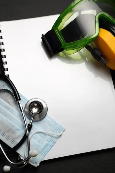 Stethoscope, mask, goggles and earphones — Stock Photo, Image