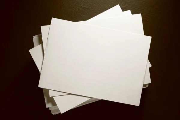 Stack of white paper cards on black — Stock Photo, Image