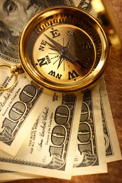 Золотой винтажный компас и деньги — стоковое фото