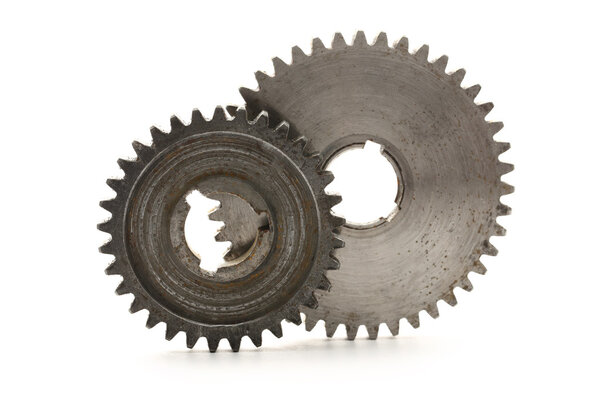 Two steel cogwheels on white background