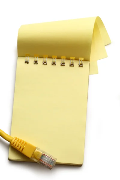 Blank yellow notepad and computer cable — Stok fotoğraf