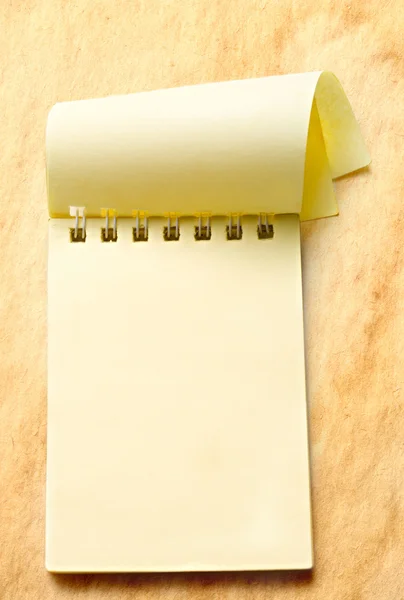 Notepad on aged paper background — Stok fotoğraf