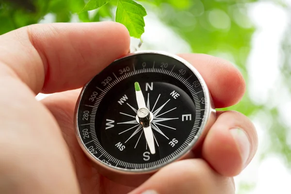 Hand holding silver black compass — Stock Photo, Image