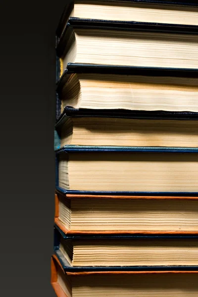 Stack of books isolated on the black background — Stock Photo, Image