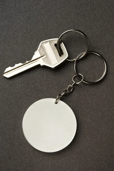 Key isolated on the dark background — Stock Photo, Image