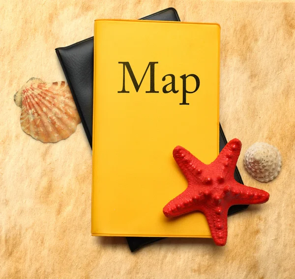 Seastar and seashells with map on stained paper — Stock Photo, Image