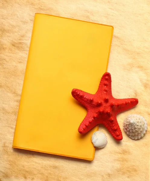 Seastar and seashells with notebook on stained paper — Stock Photo, Image