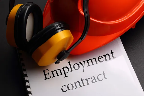Employment contract with earphones and helmet — Stock Photo, Image