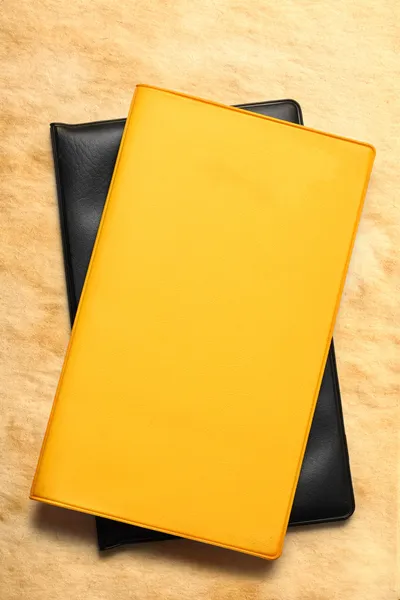 Yellow blank book on stained paper — Stock Photo, Image
