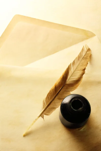 Envelope with inkwell and feather — Stock Photo, Image
