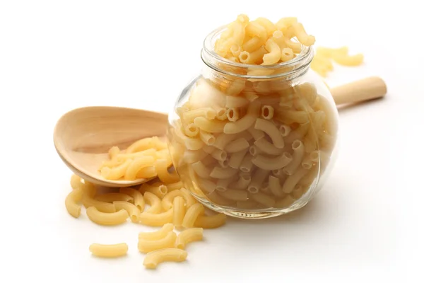 Pasta tubes in jar and spoon — Stock Photo, Image