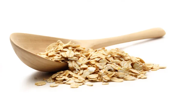 Heap of rolled oats with wooden spoon — Stock Photo, Image