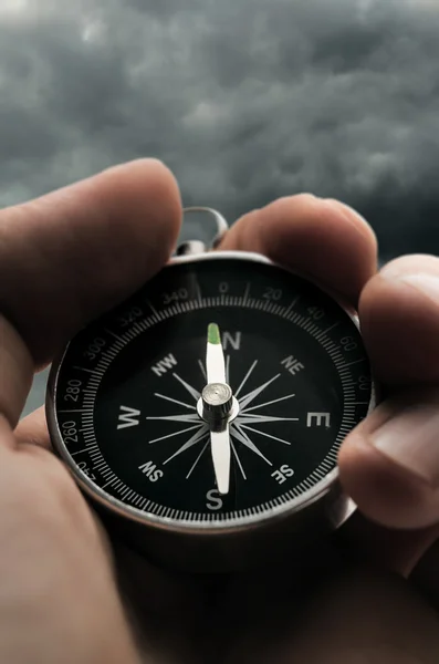 Hand holding black compass — Stock Photo, Image