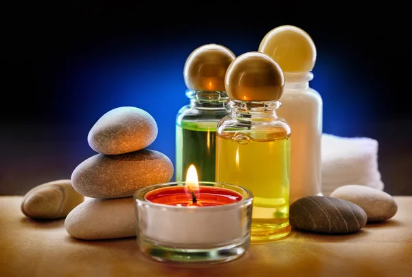 Spa stones, candle and shampoo — Stock Photo, Image