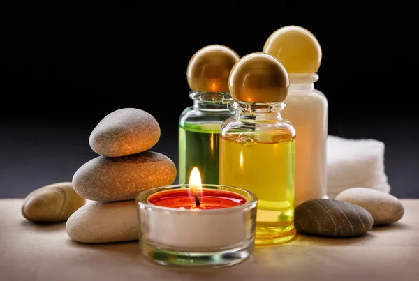 Spa stones, candle and shampoo Stock Picture