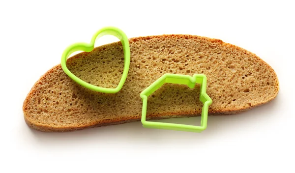 Slice of bread in house and heart form — Stock Photo, Image