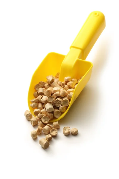 Wooden pellets on plastic shovel — Stock Photo, Image