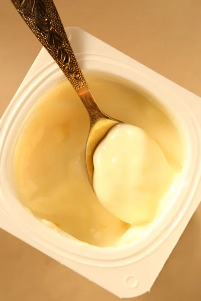 Yogurt with spoon — Stock Photo, Image