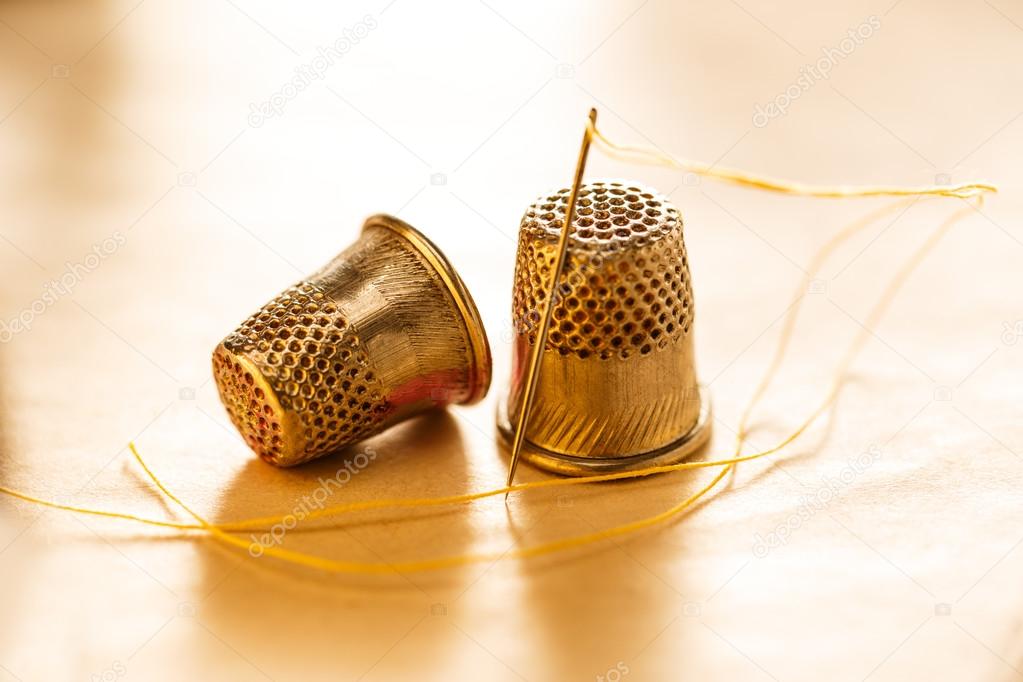 Sewing thimbles and needle Stock Photo by ©Garsya 49008047
