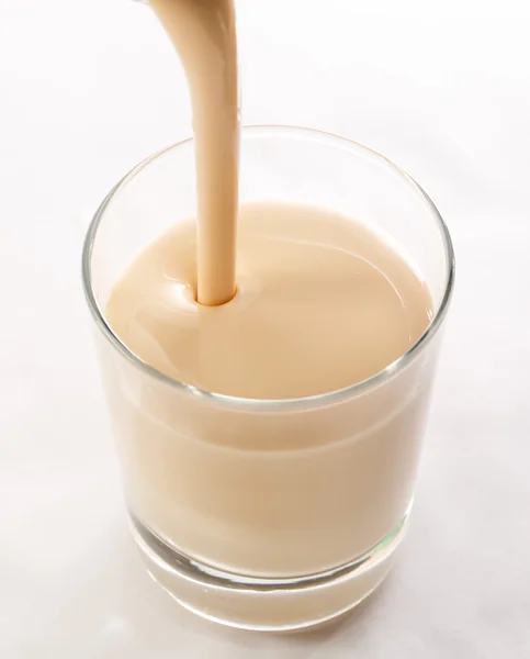 Pouring yogurt into glass — Stock Photo, Image