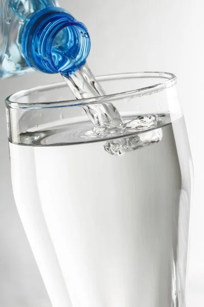 Wasser aus der Flasche gießen — Stockfoto