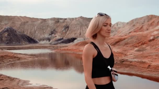 Woman walking through lifeless dried area — Stock Video