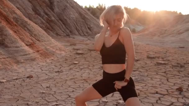 Woman dancing on lifeless dried locality — Stock Video