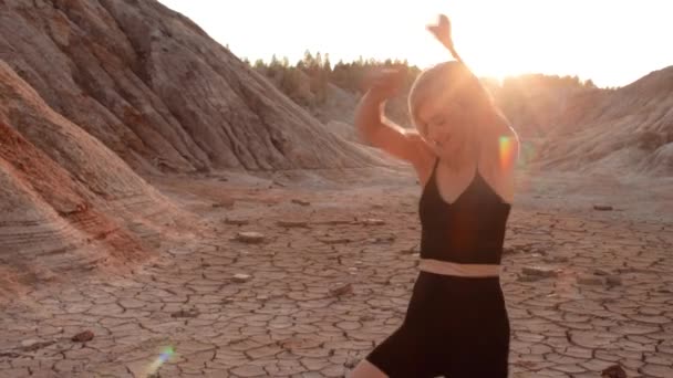 Woman dancing on lifeless dried locality — Stock Video