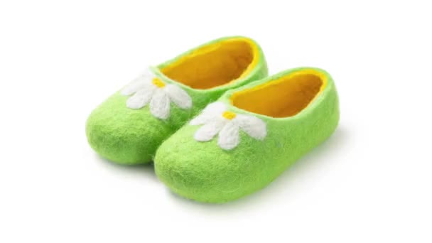 Children's slippers made of felt on a white background — Stock Video