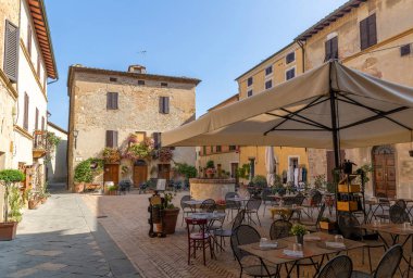 Cozy town square with restaurant in Pienza, Italy