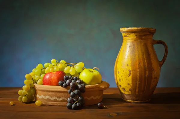 Fruta en plato de cerámica y jarrón — Foto de Stock
