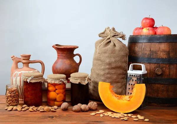 Pumpkin, walnuts, apples, and jam into jars — Stock Photo, Image