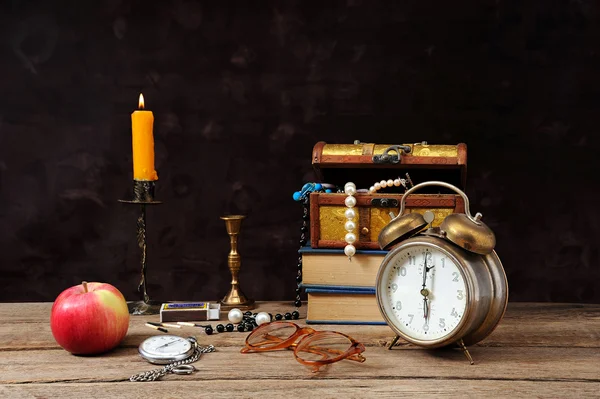 Jewelry, clocks and an apple — Stock Photo, Image