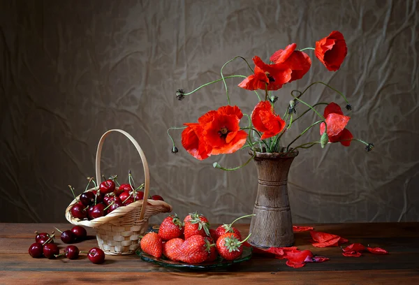 Mohn in einer Keramikvase, Kirschen und Erdbeeren — Stockfoto