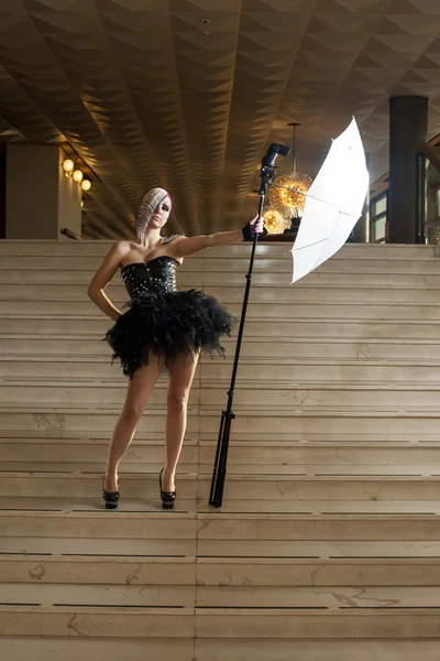 Woman with flash on stairs — Stock Photo, Image