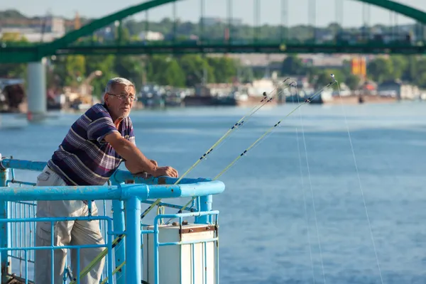 Рыбалка для пожилых людей с пристани — стоковое фото