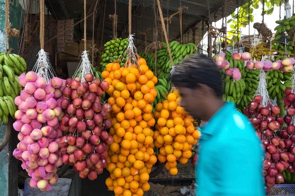 Homem local passando por stand de frutas de rua — Fotografia de Stock