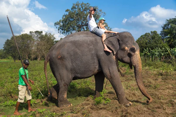 Man and child riding on the back of elephant — Stock Photo, Image