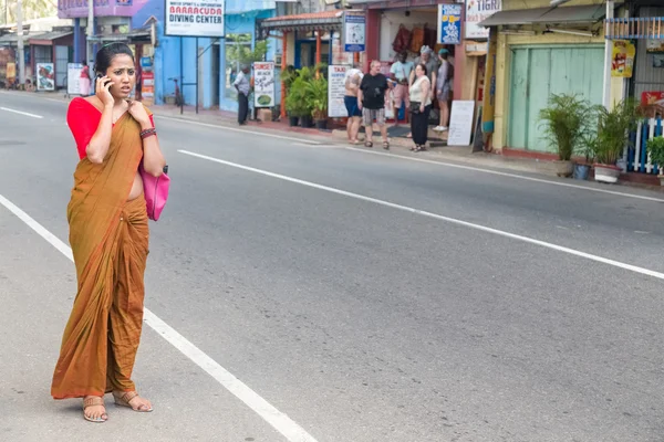 Девушка в традиционной одежде разговаривает по мобильному телефону — стоковое фото