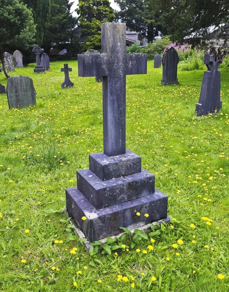 A Stone Cross in a Graveyard of Dandelions — Stock Photo, Image