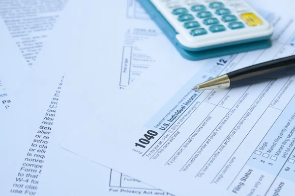 U S Tax form, pen and calculator — Stock Photo, Image