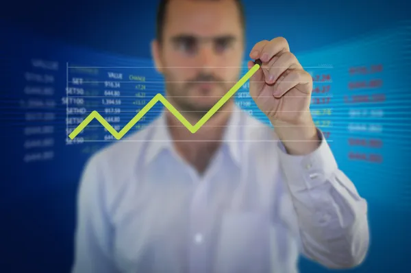 Businessman hand drawing a graph settrade — Stock Photo, Image