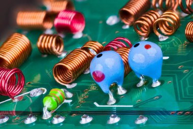 Orange and red radio-frequency coils or blue tantalum capacitors on a printed circuit board. Closeup of air core inductors soldered on green PCB. Electronic components in RF module of television card. clipart