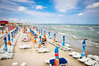 Crowded beach with tourists in Mamaia, Romania. clipart